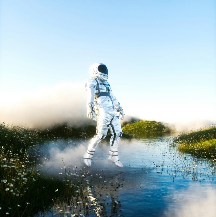 Elevated astronaut above the foggy lake